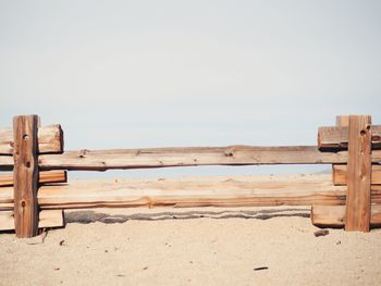 Deck chairs on beach against clear sky