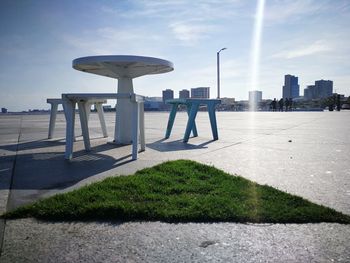 People at observation point by city against sky