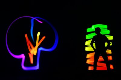 Close-up of illuminated light painting against black background