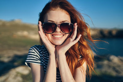 Portrait of smiling young man wearing sunglasses