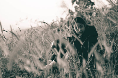 Portrait of young woman standing on field