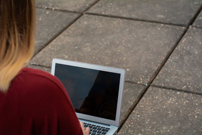 Rear view of woman using mobile phone