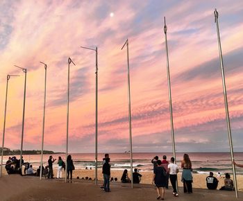 People on beach at sunset