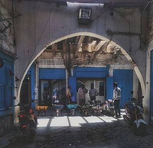 People on street amidst buildings in city