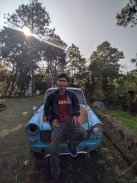 Portrait of mature man sitting against sky