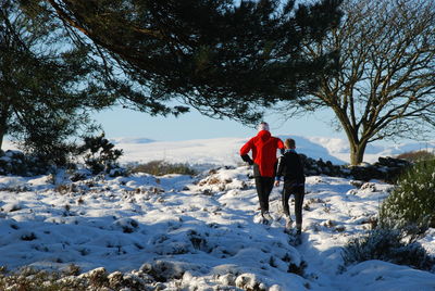 Full length of person standing on snow covered landscape