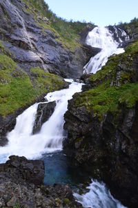 Scenic view of waterfall against sky