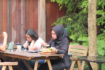 Smiling friends sitting at restaurant