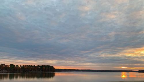 Scenic view of lake against romantic sky at sunset