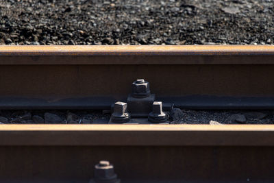 Kpo clip rail fastening system and rusty steel railway at a narrow gauge train station in germany