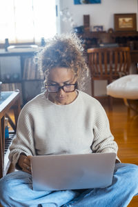 Young man using digital tablet while sitting at home