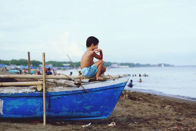 People sitting on boat in sea