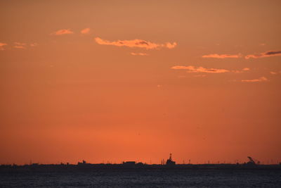 Scenic view of sea against orange sky