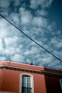 Low angle view of building against cloudy sky