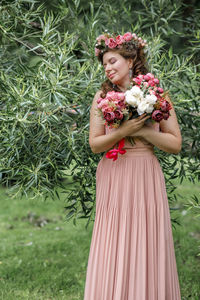 Rear view of woman standing against plants