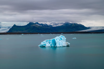 Scenic view of frozen lake against mountain range