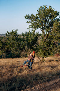 Man playing on field against clear sky