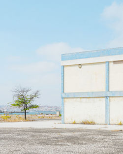 Road by building against sky