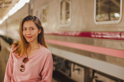 Portrait of woman at railroad station platform