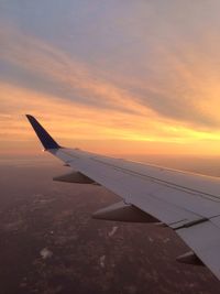 Cropped image of airplane flying over clouds