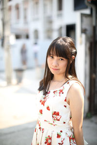 Portrait of woman standing in city