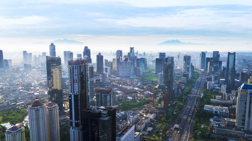 Aerial view of modern buildings in city against sky