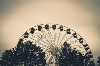 Low angle view of ferris wheel against clear sky