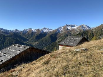 Scenic view of mountains against clear blue sky