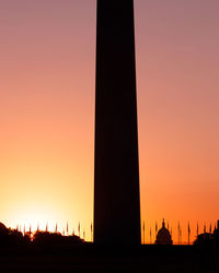 Low angle view of silhouette tower during sunset