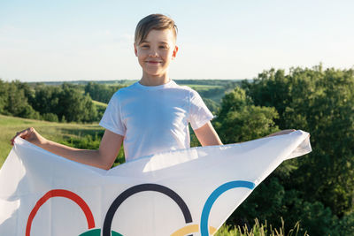 Portrait of boy holding flag