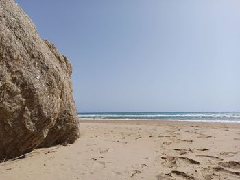 Scenic view of beach against clear sky