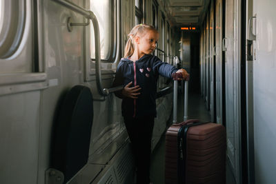 Portrait of young woman sitting in bus