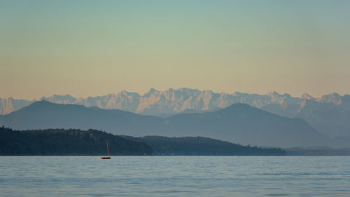 Scenic view of lake and mountains against clear sky