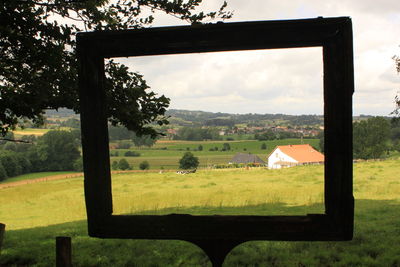 Scenic view of grassy field against cloudy sky