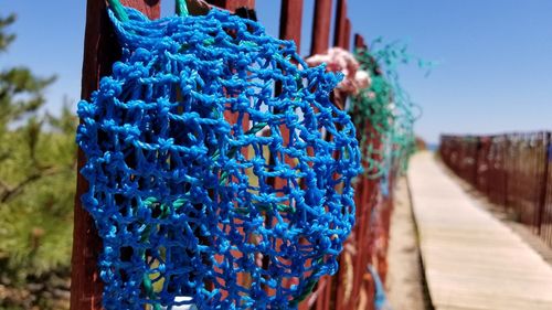 Close-up of multi colored rope hanging on footpath