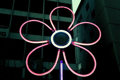 Close-up of illuminated metal structure at night