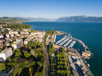 High angle view of buildings by sea against sky