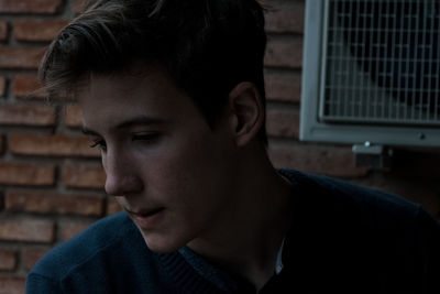 Close-up of young man looking down