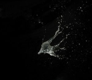 High angle view of water splashing on black background