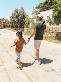 Full length of boy running on road