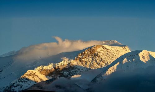 Scenic view of snowcapped mountains against sky