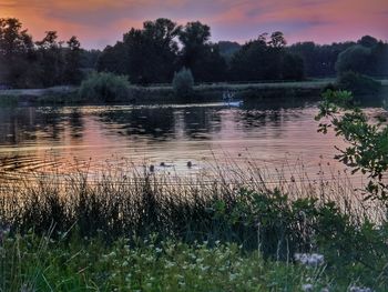 Scenic view of lake against sky during sunset