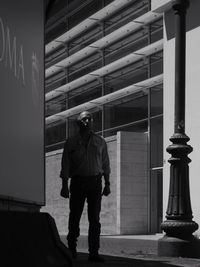 Rear view of man standing by building