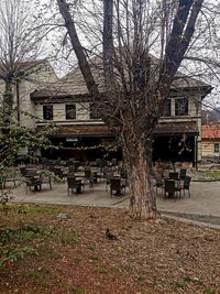 Park bench by building in city