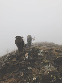 People on mountain against sky