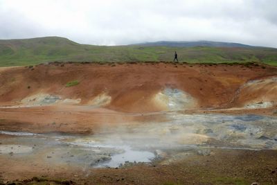Scenic view of mountains against cloudy sky