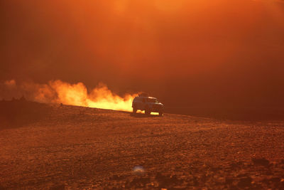 Scenic view of fire on field at night