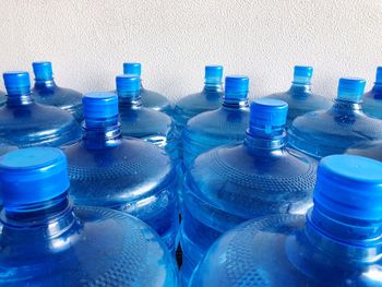 Close-up of bottles against blue wall