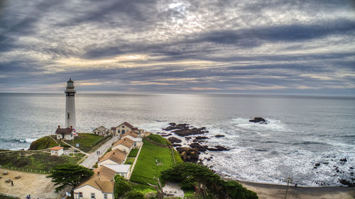 Scenic view of sea and buildings against sky during sunset