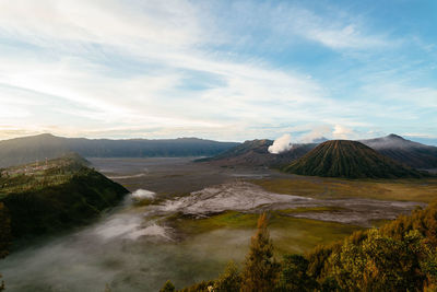 View of volcanic landscape against cloudy sky